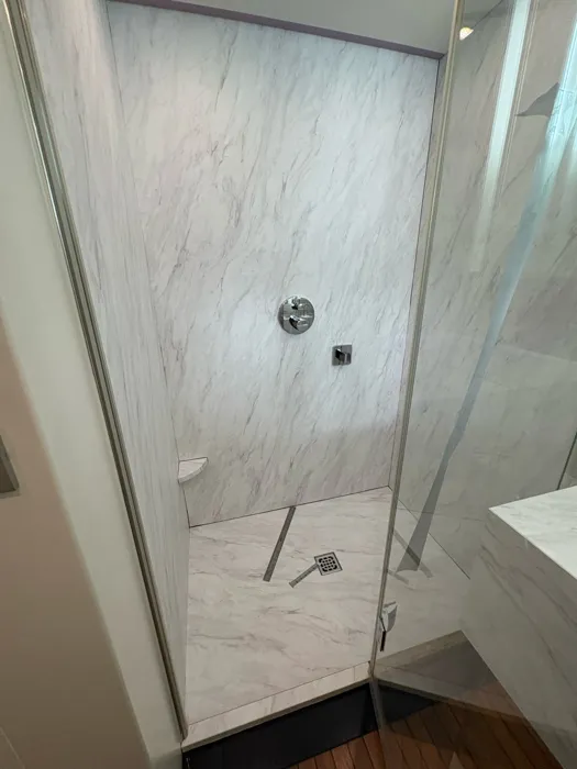 Yacht shower walls wrapped in a marble finish